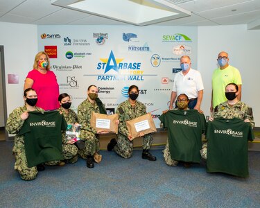 STARBASE Victory staff and NNSY Sailor volunteers pose for a picture together with the t-shirts and packages they had helped put together. The top two gentlemen to the far right are (from left to right) STARBASE Victory Executive director Bill Hayden and board member/retired NNSY employee Robert Fogel.