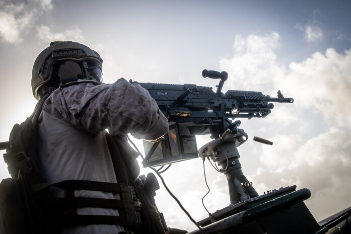A U.S. Marine fires at targets during a live fire machine gun shoot with Netherlands Marines from the 32nd Raiding Squadron near Netherlands Marine Barracks Savaneta, Aruba, Nov. 23.