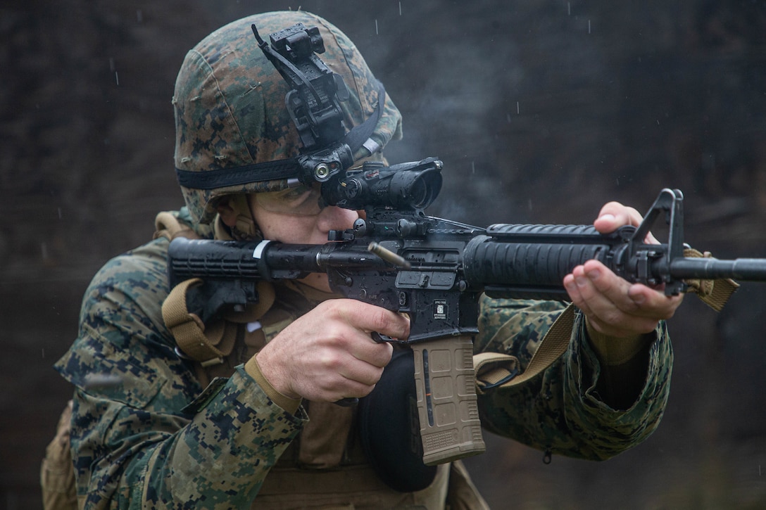 A U.S. Marine fires an M4 carbine during military operations on urbanized terrain training as part of Marine Expeditionary Force 20.1 on Fort Drum, New York Nov. 1.