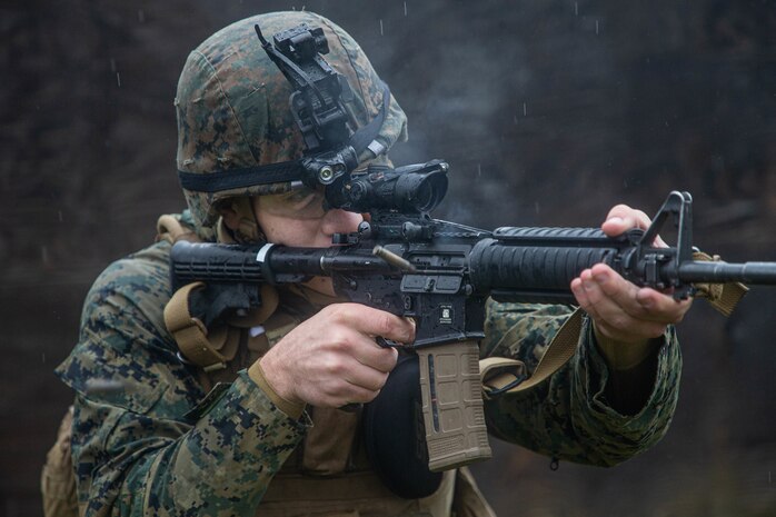 A U.S. Marine fires an M4 carbine during military operations on urbanized terrain training as part of Marine Expeditionary Force 20.1 on Fort Drum, New York Nov. 1.