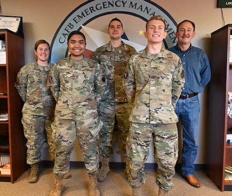 The 14th Civil Engineer Squadron Readiness and Emergency Management flight stands in front of their logo Nov. 24, 2020, on Columbus Air Force Base, Miss. The R&EM flight won the Major Command level Col. Frederick J. Reimer Award which honors the lifetime accomplishments of the man considered to be the founder of Disaster Preparedness and a pioneer of the Air Force’s current Readiness Program. (U.S. Air Force photo by Senior Airman Jake Jacobsen)