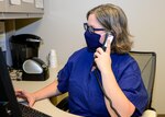 t. j.g. Ronni Zona, Naval Medical Center Portsmouth’s COVID-19 Call Center division officer, answers a call Sept. 3.