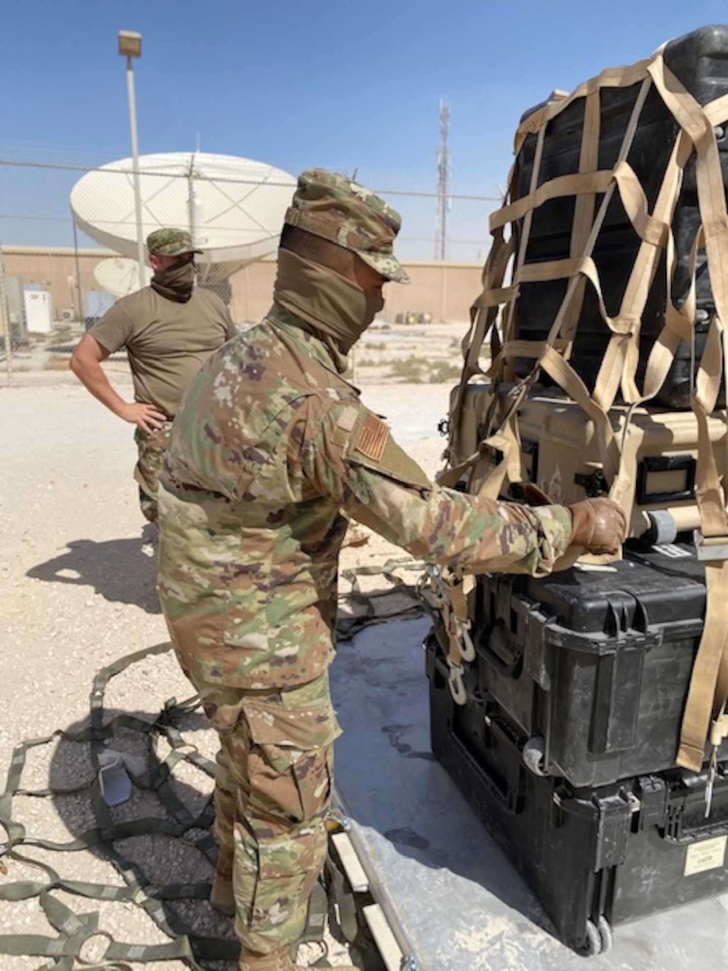 U.S. Air Force Airman 1st Class Albert Nofuente, assigned to the 379th Expeditionary Communication Squadron at Al Udeid Air Base, Qatar, secures communication equipment and radios onto a cargo pallet Oct. 9, 2020. The 379th ECS collaborated with the 379th Expeditionary Logistics Readiness Squadron to train on how to effectively load and move communication equipment in the event of a real-world emergency where they would need it at an alternate location. (U.S. Air Force courtesy photo)