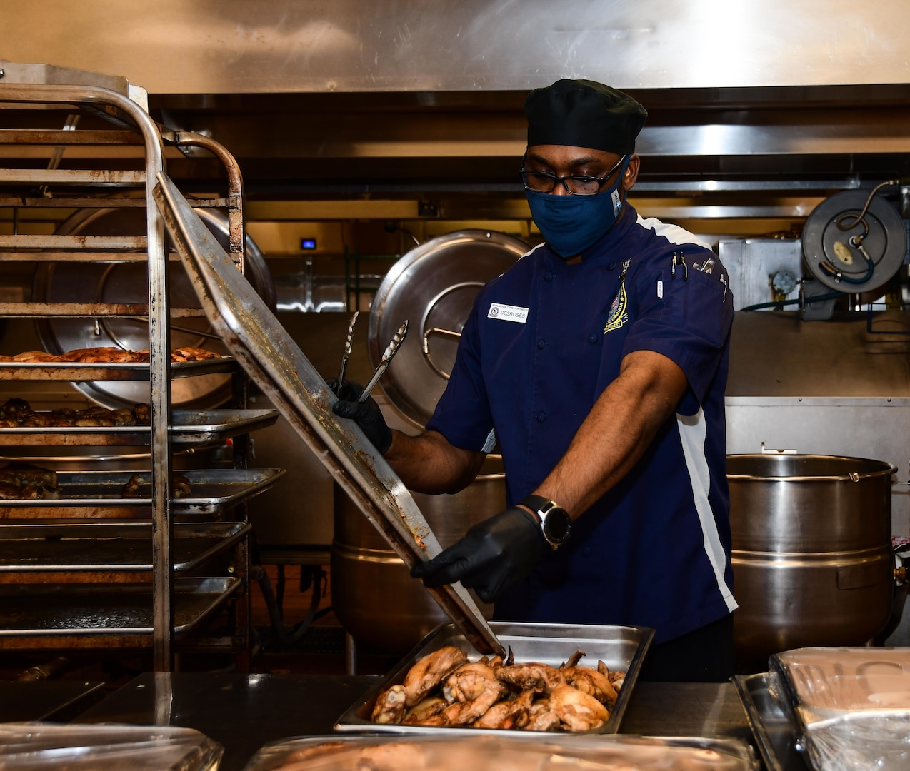 ulinary Specialist 2nd Class Denzel Desroses, Naval Medical Center Portsmouth’s (NMCP) galley watch captain, prepares chicken in the galley kitchen, Dec. 1.