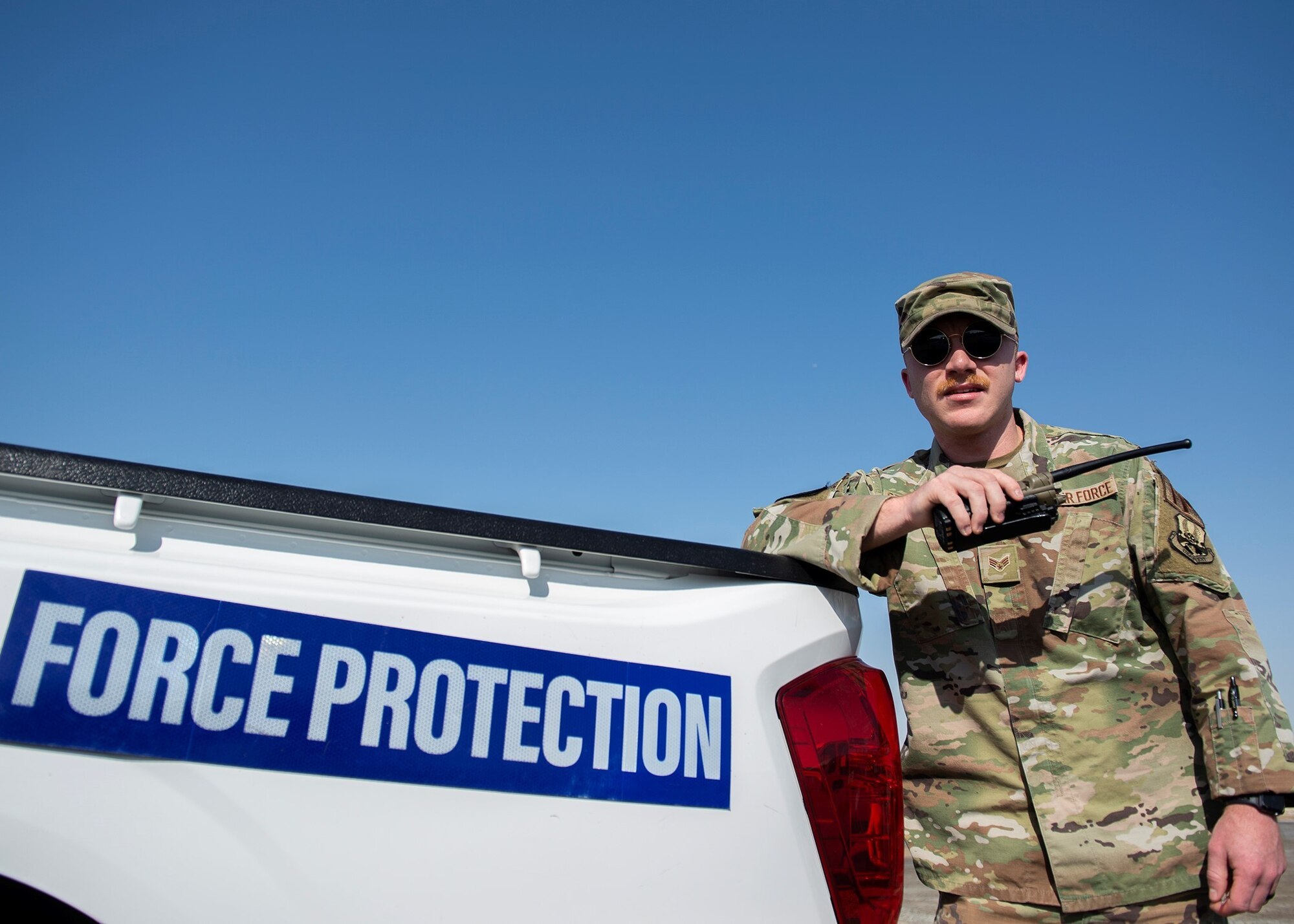 U.S. Air Force Senior Airman Robert Stansberry, 380th Expeditionary Security Forces Squadron Force Protection Hawkeye flight escort, uses a radio to contact other FP personnel, at Al Dhafra Air Base, United Arab Emirates, Nov. 22, 2020.