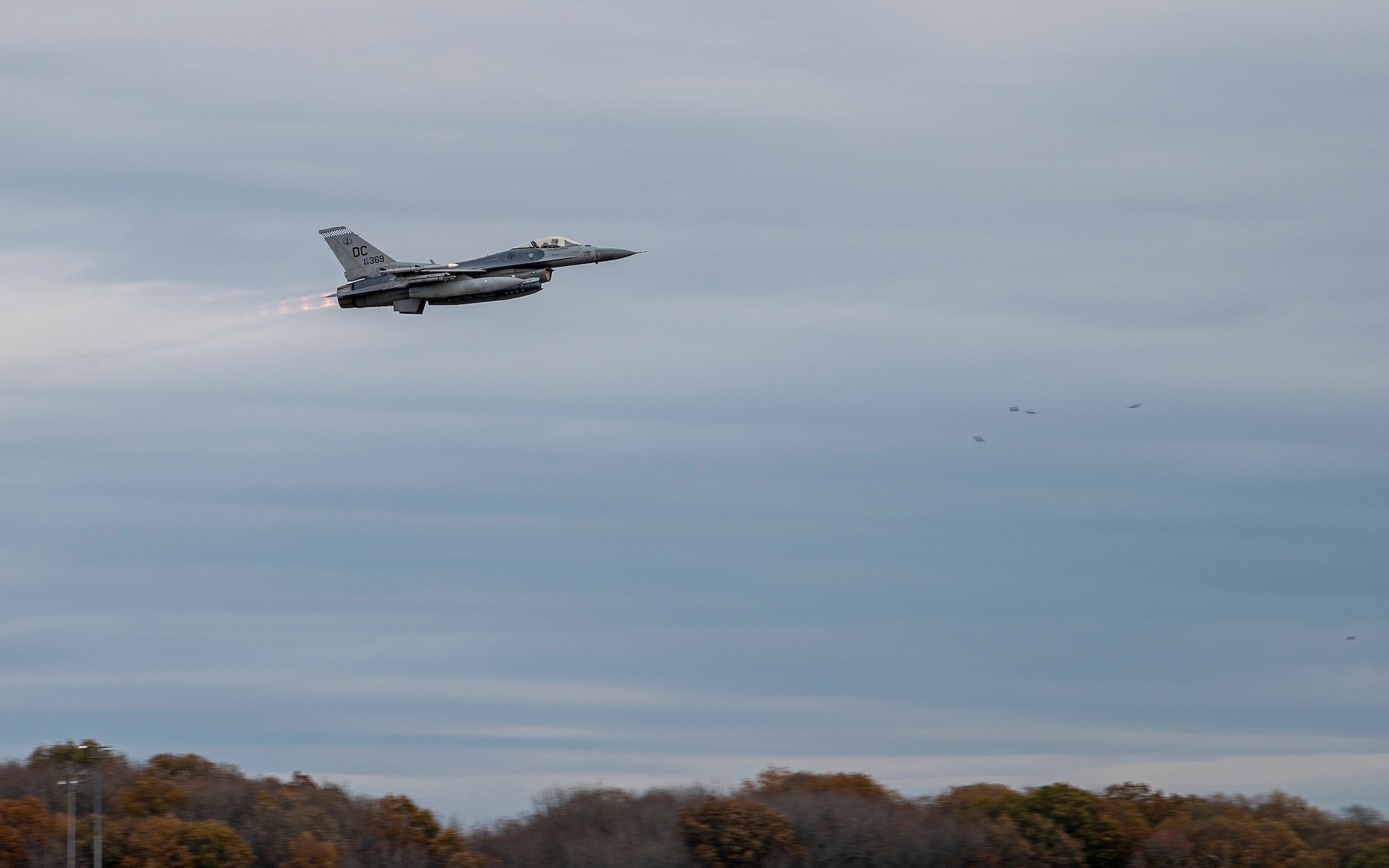 An F-16 Fighting Falcon, assigned to the 121st Fighter Squadron at Joint Base Andrews, Maryland, takes off at Dover Air Force Base, Delaware, Nov. 25, 2020. The aircraft stopped at Dover Air Force Base during routine flight training operations. The base prioritizes providing unrivaled installation support for mission partners, transit aircraft and neighboring installations. (U.S. Air Force photo by Senior Airman Christopher Quail)