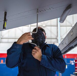 Tech. Sgt. Joseph Ramos, 149th Fighter Wing aircraft armament systems technician, removes a panel from an F-16 Fighting Falcon undergoing maintenance Nov. 30 at Joint Base San Antonio-Lackland.