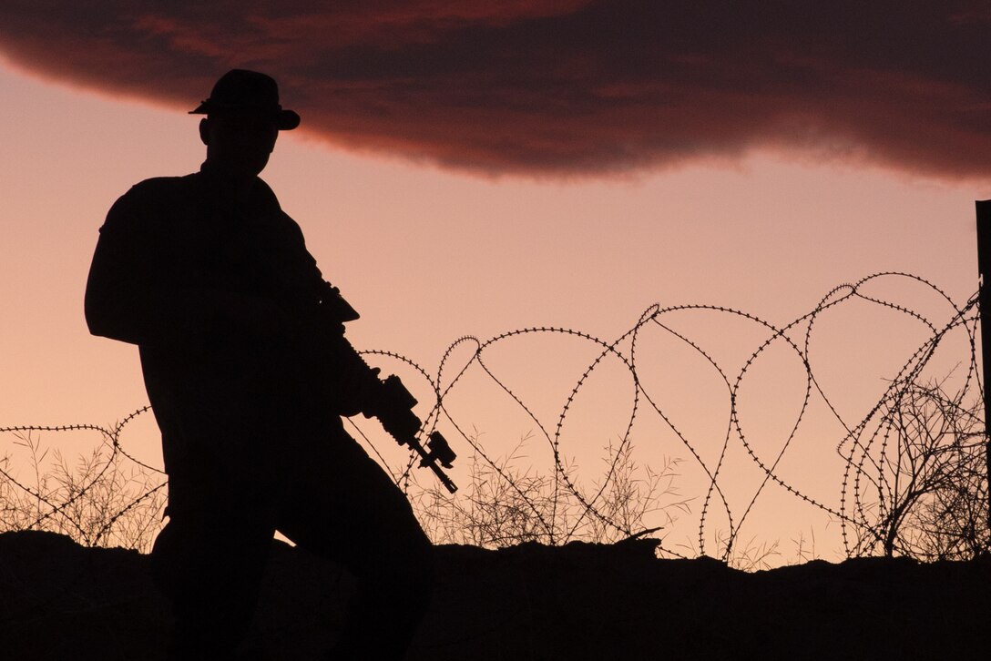 A U.S. Marine from Co.A, 1st Battalion, 7th Marine Regiment, 1st Marine Division, observes the Military Operations in Urban Terrain (MOUT) town during the Marine Corps Combat Readiness Evaluation (MCCRE) at Marine Corps Air Ground Combat Center Twentynine Palms, Calif., Nov. 3, 2020. The purpose of a MCCRE, is to formally evaluate the unit’s core and/or assigned mission essential tasks in order to ensure service standardization and combat readiness. (U.S. Marine Corps photo by Lance Cpl. Cameron Rowe)