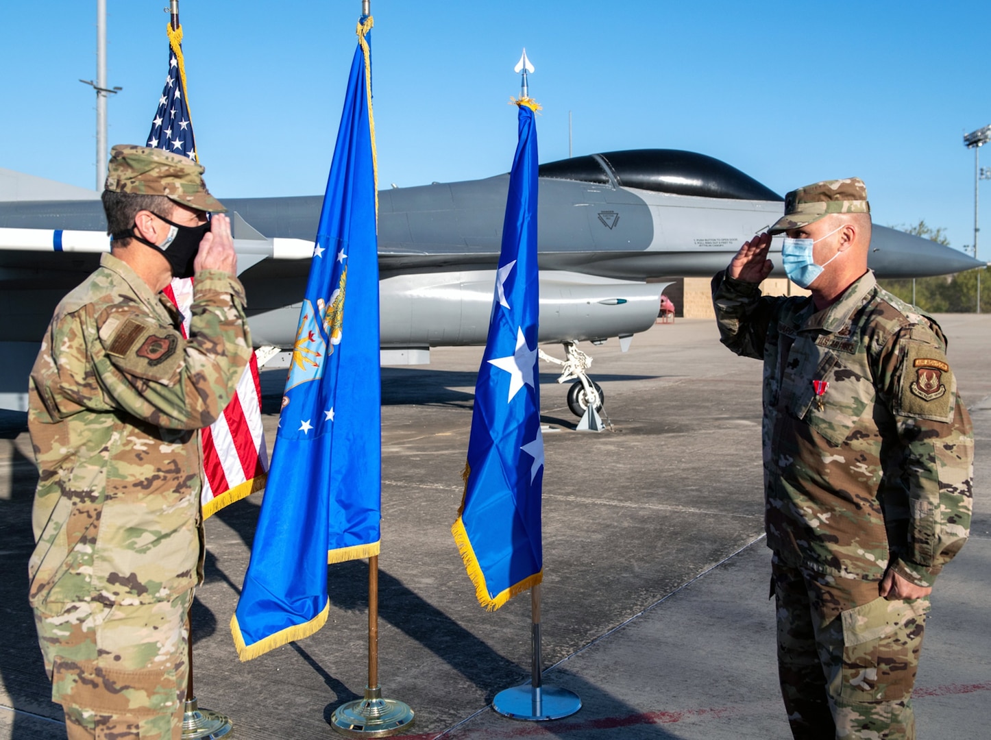 Air Force Lt. Gen. Shaun Morris (left), Air Force Life Cycle Management Center commander, returns a salute after presenting Lt. Col. Bryan Howard (right), Deputy Branch Chief Sustainment, with the Bronze Star Nov. 16 at Joint Base San Antonio-Chapman Annex.