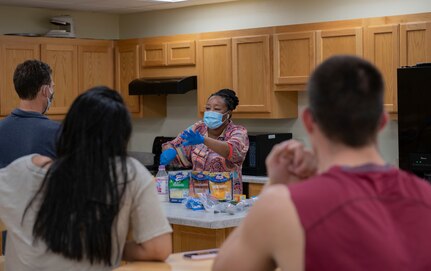 Tonya Lee, Joint Base San Antonio-Randolph violence prevention integrator, provides a cooking lesson at JBSA-Randolph, Texas, Nov. 20, 2020.