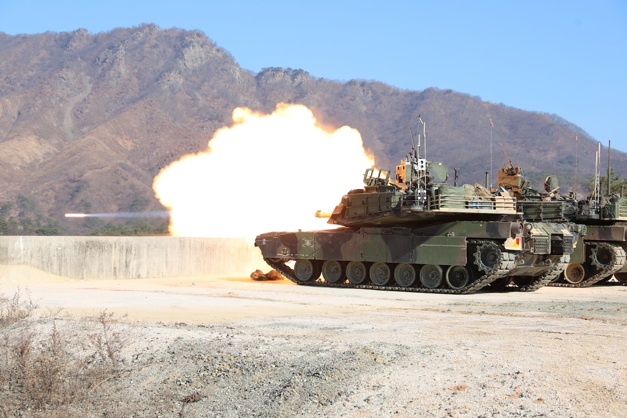 A tank fires a projectile.