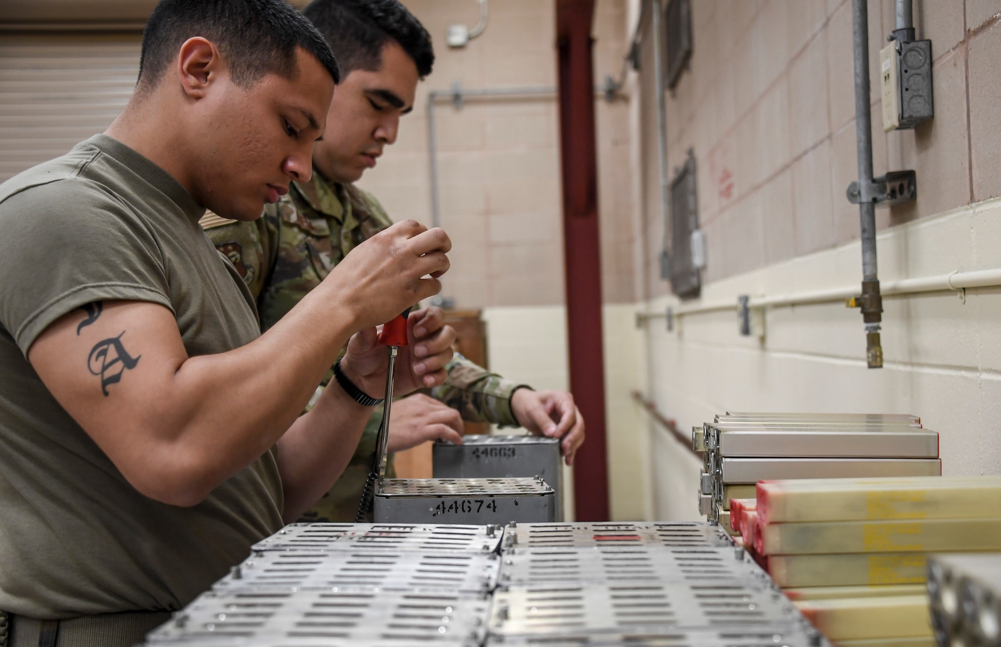Airman 1st Class Anthony Acosta and Airman 1st Class John Aldecoa, 144th Maintenance Squadron, breaks down countermeasures to be stored and shipped back to Fresno, California, during the exercise Checkered Flag, Tyndall Air Force Base, Florida, Nov. 9, 2020.