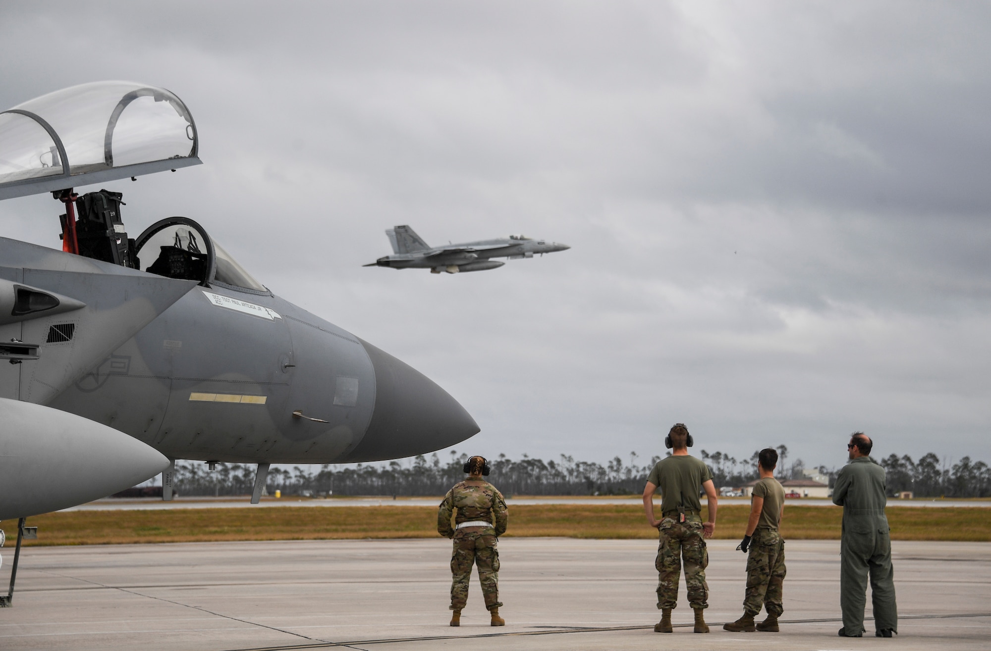 U.S. Air Force Airmen from the 144th watch a U.S. Navy F/A-18E Super Hornet fighter jet depart   Tyndall Air Force Base, Florida, Nov. 10, 2020 after the conclusion of  Checkered Flag.
