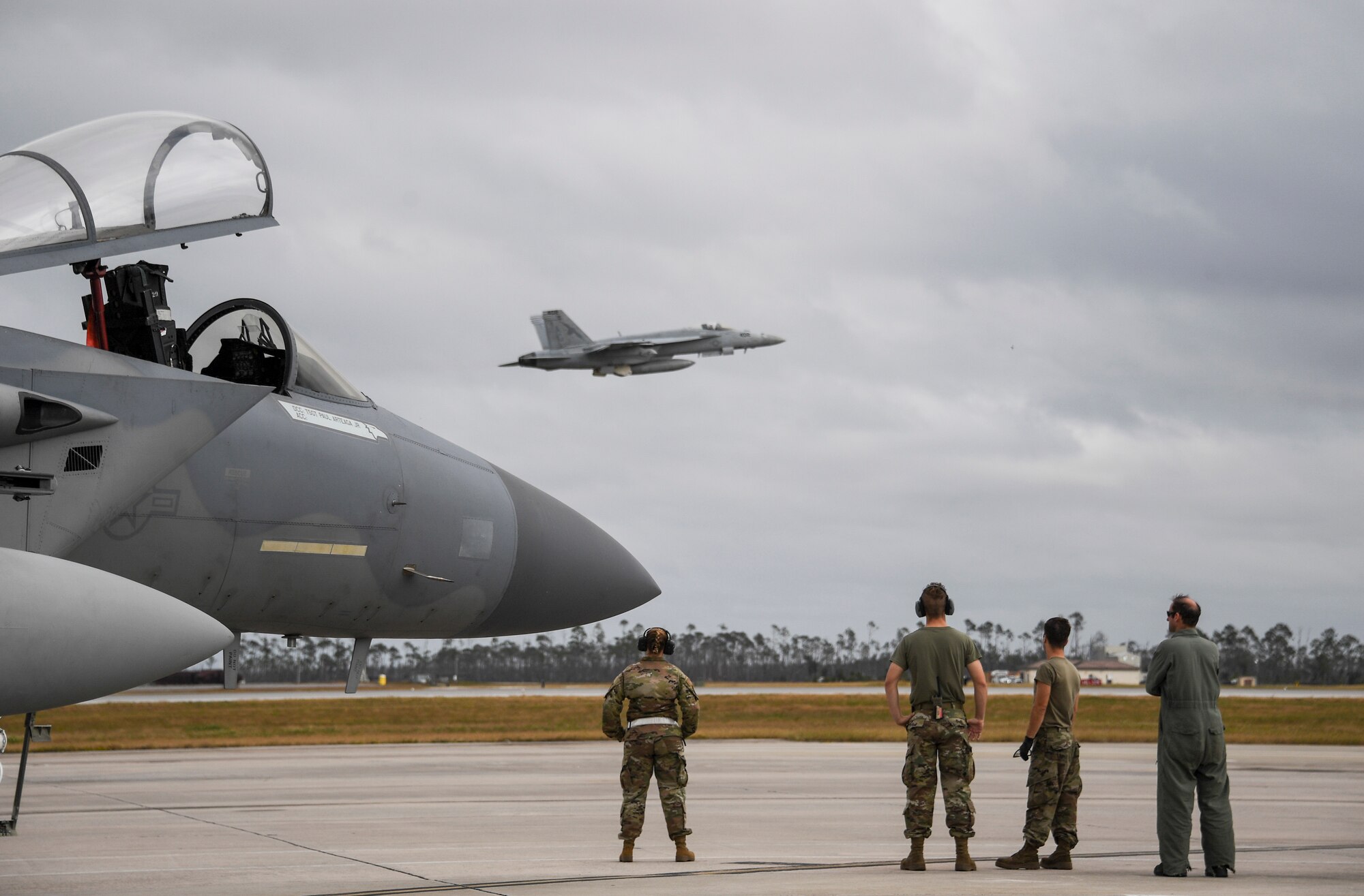 U.S. Air Force Airmen from the 144th watch a U.S. Navy F/A-18E Super Hornet fighter jet depart   Tyndall Air Force Base, Florida, Nov. 10, 2020 after the conclusion of  Checkered Flag.