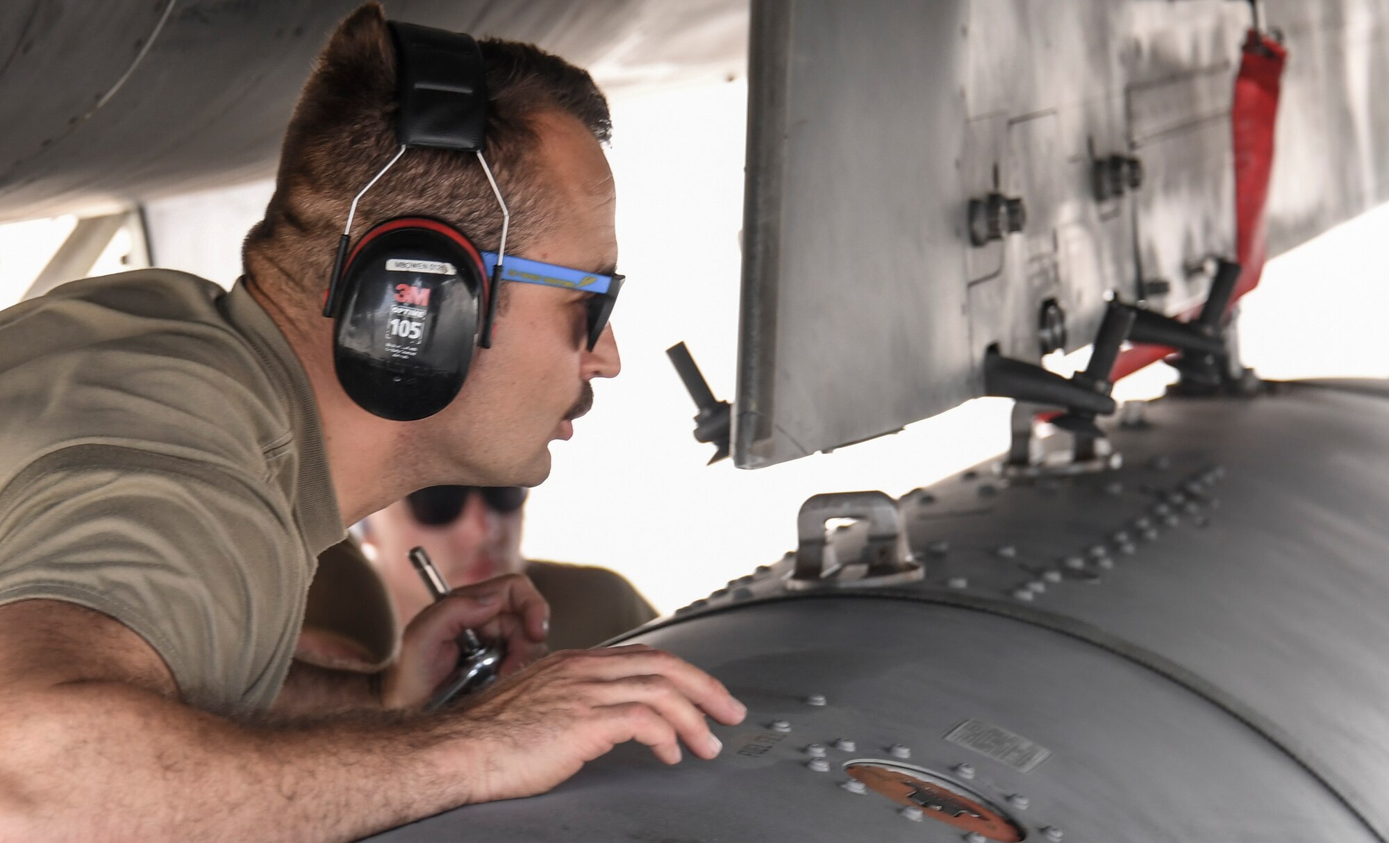 Tech. Sgt. Michael Bowen, 144th Maintenance Squadron, hooks an external fuel tank to a U.S. Air Force F-15C Eagle fighter jet during Checkered Flag, Tyndall Air Force Base, Florida, Nov. 9, 2020.