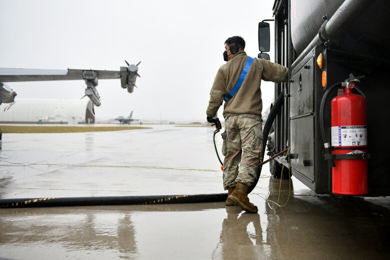 U.S. Air Force Senior Airman Brandon Gomez, 31st Logistics Readiness Squadron fuels distribution operator, fuels an F-16 Fighting Falcon at Aviano Air Base, Italy, Dec. 2, 2020. The 31st Fighter Wing participated in surge flying throughout the week. LRS airmen are one of many career fields essential to flightline operations, especially during surge operations, as they deliver much-needed fuels for those aircraft to operate. (U.S. Air Force photo by Staff Sgt. K. Tucker Owen)