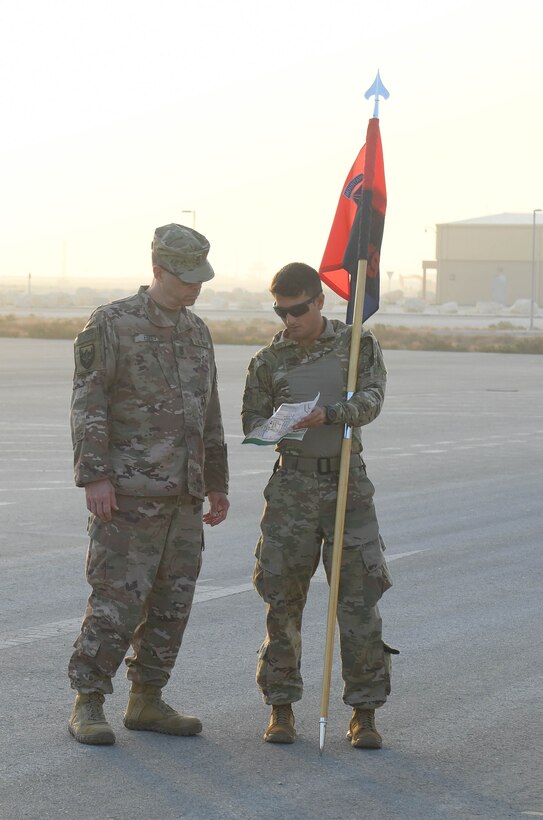 U.S. Army 1st Lt. Keven Cordero, right, executive officer with the headquarters support element of U.S. Forces Afghanistan, explains the route for the Christmas Ration Ruck March to U.S. Navy Master Chief Petty Officer Mark Ennis, the USFOR-A senior enlisted leader Dec. 1, 2020. Cordero organized the charitable event, which brought members of the Air Force, Army, Navy and Marine Corps deployed to Al Udeid Air Base, Qatar, together and partnered with the USO to donate toiletries, children's books and food items back to the United States. (U.S. Air Force photo by Staff Sgt. Kayla White)