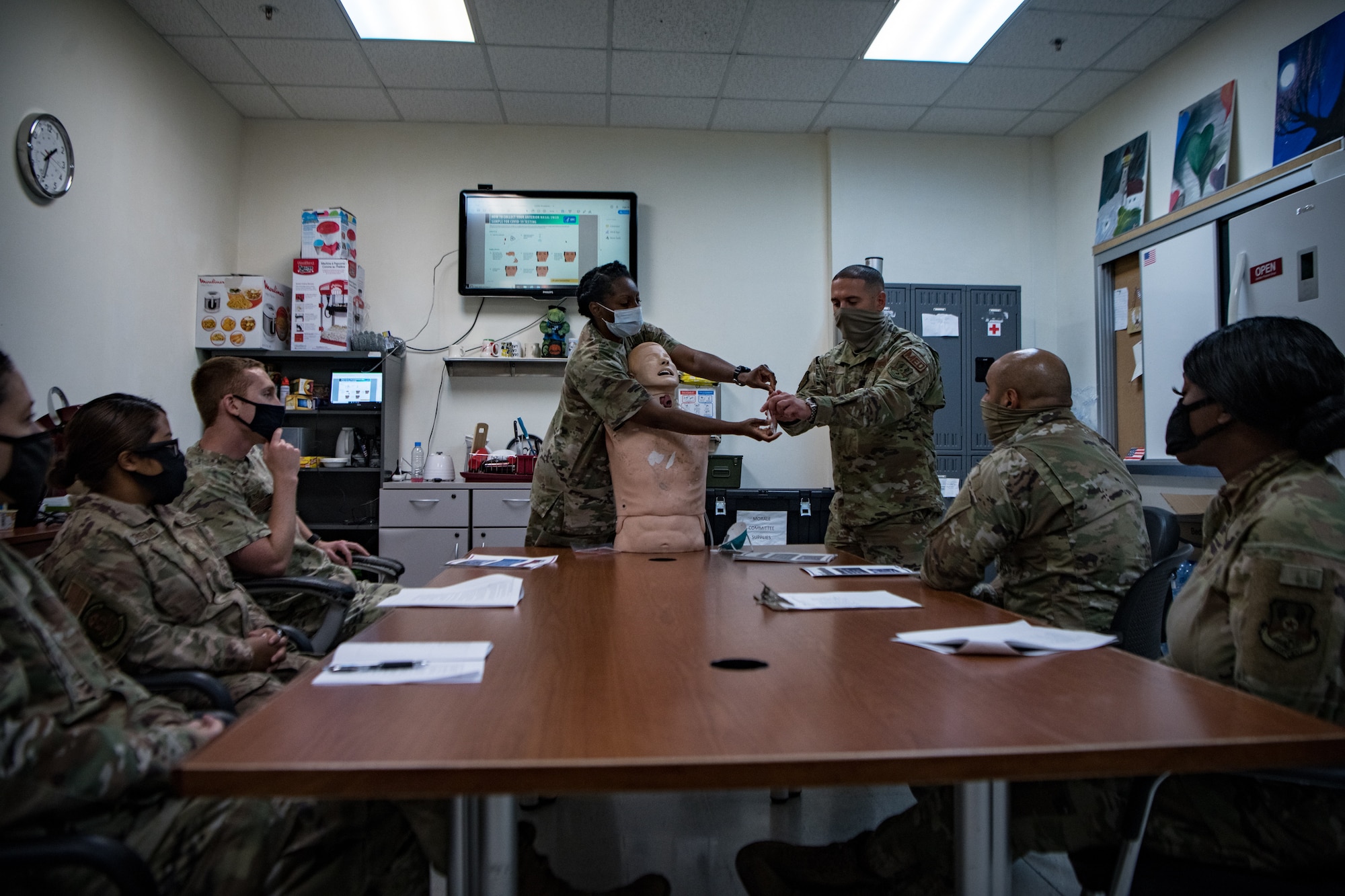 Airmen demonstrate how to administer a COVID-19 anterior nasal swab test