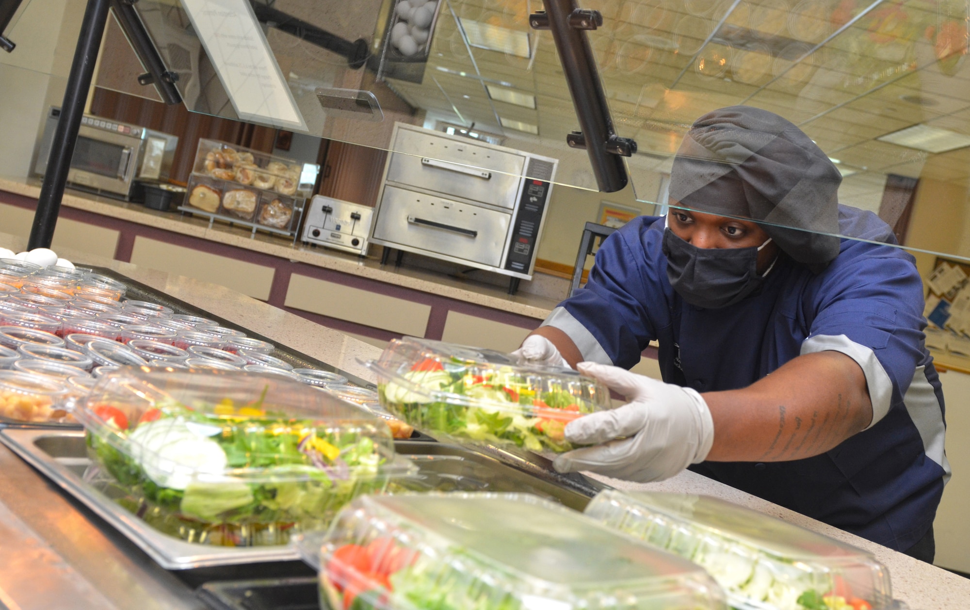 Image of Navy Culinary Specialist 3rd Class Keith Johnson prepping food.