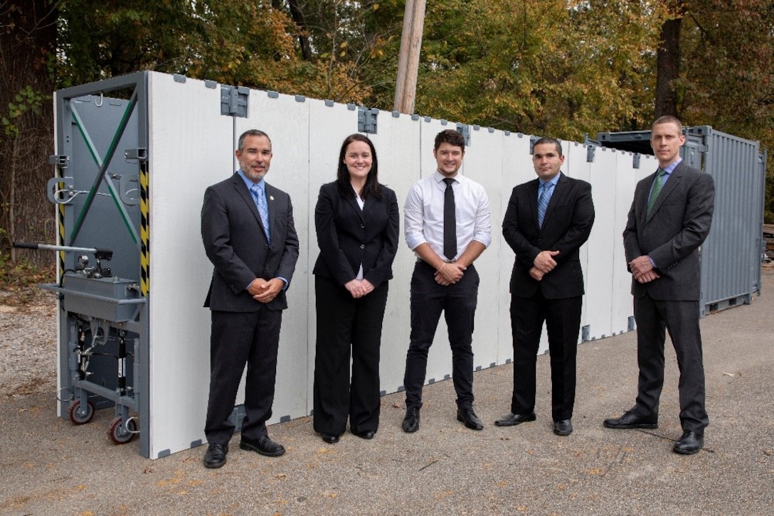 The Ready Armor Protection for Instant Deployment, or RAPID, invention team poses in front of their invention. Team members include, from left, the U.S. Army Engineer Research and Development Center-Geotechnical and Structures Laboratory’s Survivability Engineering Branch members Omar Esquilin-Mangual, team leader; Dr. Catherine Stephens; Erik Chappell; branch chief Omar Flores; Carey Price and Andrew Edwards of Edwards Design and Fabrication, not pictured.