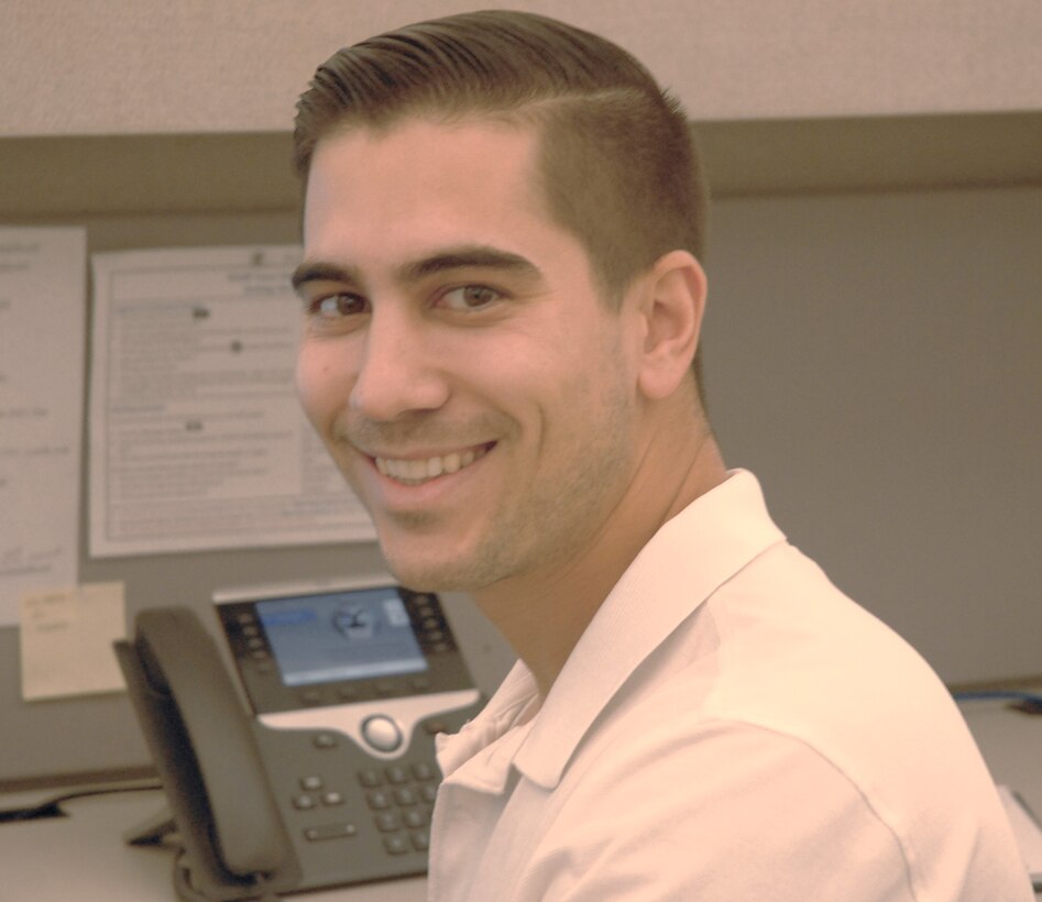 Ryan Cunningham, a contracting officer in DLA Troop Support’s Industrial Hardware supply chain, poses at his desk Oct. 23, 2019 in Philadelphia.