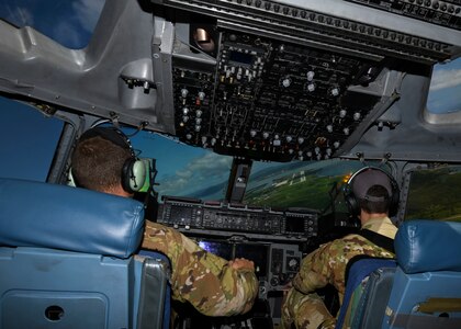Capt. Chris Brown, a C-17 Globemaster III pilot, and Capt. Spencer Dewey, a C-17 Globemaster III aircraft commander, who are both assigned to the 15th Airlift Squadron at Joint Base Charleston, S.C., prepare to land at Naval Station Guantanamo Bay (NSGB), Cuba, Nov. 12, 2020. The 15th AS flew an off-station trainer to NSGB to deliver two Halverson loaders and bring two Halverson loaders back to Charleston. The aircrew also conducted airfield and low-level training at Guantanamo Bay, Cuba, the Florida Keys, Lakeland Linder International Airport and Patrick Air Force Base. Two Airmen, assigned to the 628th Logistics Readiness Squadron at Joint Base Charleston, repaired two loaders before they were loaded onto the jet.