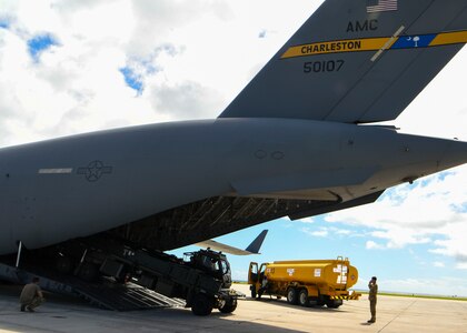 Tech. Sgt. Shane Thaxton, a loadmaster assigned to the 15th Airlift Squadron at Joint Base Charleston, S.C., guides a Halverson loader off of a C-17 Globemaster III at Naval Station Guantanamo Bay (NSGB), Cuba, Nov. 12, 2020.  The 15th AS flew an off-station trainer to NSGB to deliver two Halverson loaders and bring two Halverson loaders back to Charleston. The aircrew also conducted airfield and low-level training at Guantanamo Bay, Cuba, the Florida Keys, Lakeland Linder International Airport and Patrick Air Force Base. Two Airmen, assigned to the 628th Logistics Readiness Squadron at Joint Base Charleston, repaired two loaders before they were loaded onto the jet.