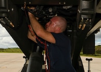 Senior Airman Thomas Franklin, a vehicle mechanic assigned to the 628th Logistics Readiness Squadron at Joint Base Charleston, S.C., performs mechanical works on a Halverson loader at Naval Station Guantanamo Bay (NSGB), Cuba, Nov. 12, 2020.  The 15th AS flew an off-station trainer to NSGB to deliver two Halverson loaders and bring two Halverson loaders back to Charleston. The aircrew also conducted airfield and low-level training at Guantanamo Bay, Cuba, the Florida Keys, Lakeland Linder International Airport and Patrick Air Force Base. Two Airmen, assigned to the 628th Logistics Readiness Squadron at Joint Base Charleston, repaired two loaders before they were loaded onto the jet.