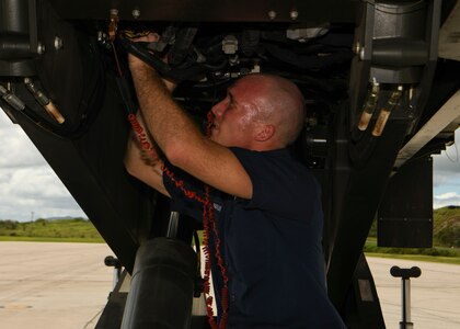 Senior Airman Thomas Franklin, a vehicle mechanic assigned to the 628th Logistics Readiness Squadron at Joint Base Charleston, S.C., performs mechanical works on a Halverson loader at Naval Station Guantanamo Bay (NSGB), Cuba, Nov. 12, 2020.  The 15th AS flew an off-station trainer to NSGB to deliver two Halverson loaders and bring two Halverson loaders back to Charleston. The aircrew also conducted airfield and low-level training at Guantanamo Bay, Cuba, the Florida Keys, Lakeland Linder International Airport and Patrick Air Force Base. Two Airmen, assigned to the 628th Logistics Readiness Squadron at Joint Base Charleston, repaired two loaders before they were loaded onto the jet.