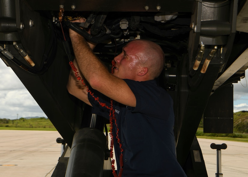 Senior Airman Thomas Franklin, a vehicle mechanic assigned to the 628th Logistics Readiness Squadron at Joint Base Charleston, S.C., performs mechanical works on a Halverson loader at Naval Station Guantanamo Bay (NSGB), Cuba, Nov. 12, 2020.  The 15th AS flew an off-station trainer to NSGB to deliver two Halverson loaders and bring two Halverson loaders back to Charleston. The aircrew also conducted airfield and low-level training at Guantanamo Bay, Cuba, the Florida Keys, Lakeland Linder International Airport and Patrick Air Force Base. Two Airmen, assigned to the 628th Logistics Readiness Squadron at Joint Base Charleston, repaired two loaders before they were loaded onto the jet.