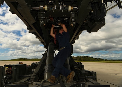 Senior Airman Thomas Franklin, a vehicle mechanic assigned to the 628th Logistics Readiness Squadron at Joint Base Charleston, S.C., performs mechanical work on a Halverson loader at Naval Station Guantanamo Bay (NSGB), Cuba, Nov. 12, 2020.  The 15th AS flew an off-station trainer to NSGB to deliver two Halverson loaders and bring two Halverson loaders back to Charleston. The aircrew also conducted airfield and low-level training at Guantanamo Bay, Cuba, the Florida Keys, Lakeland Linder International Airport and Patrick Air Force Base. Two Airmen, assigned to the 628th Logistics Readiness Squadron at Joint Base Charleston, repaired two loaders before they were loaded onto the jet.