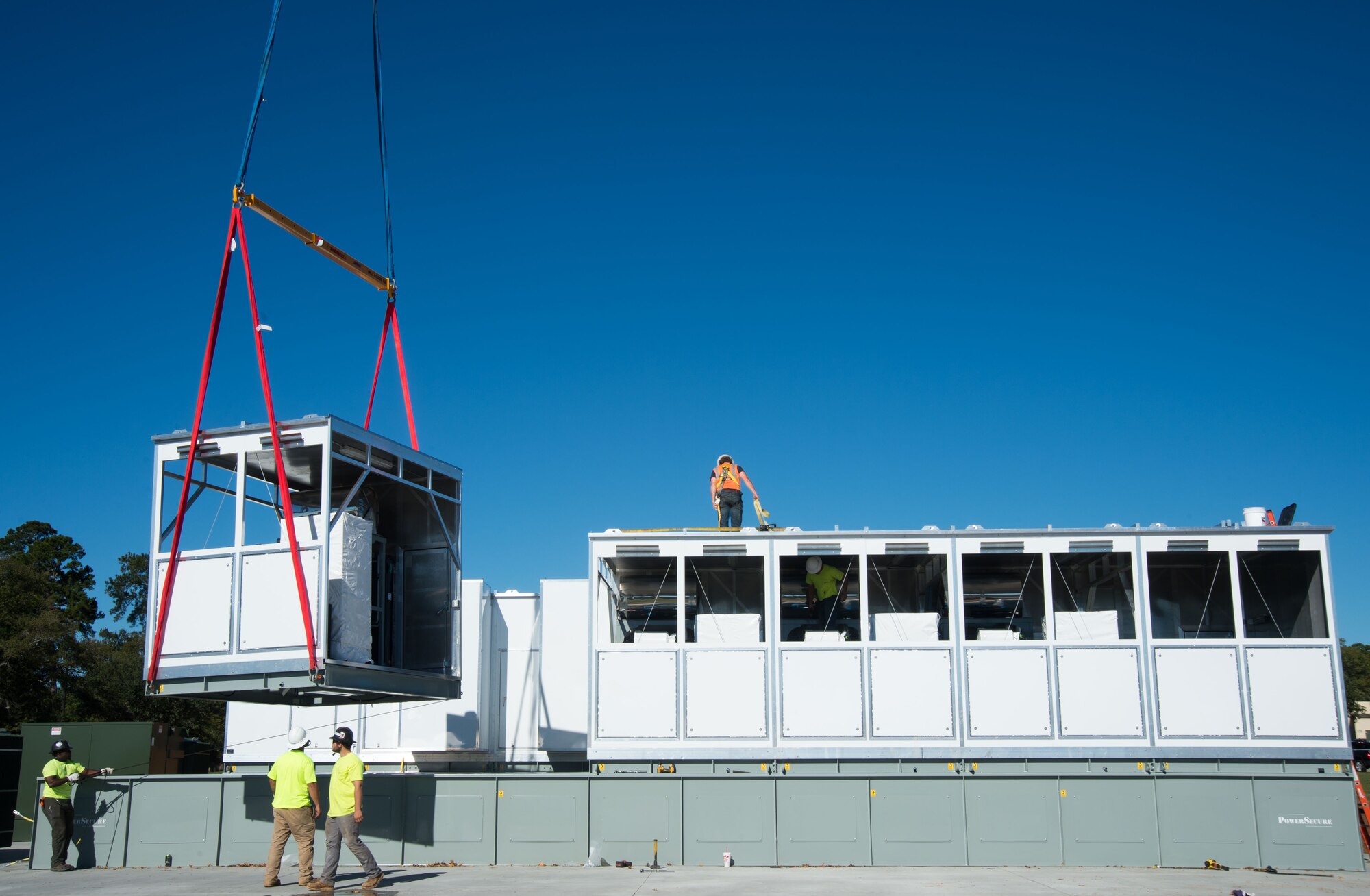 Contractors assemble a microgrid at a construction site.