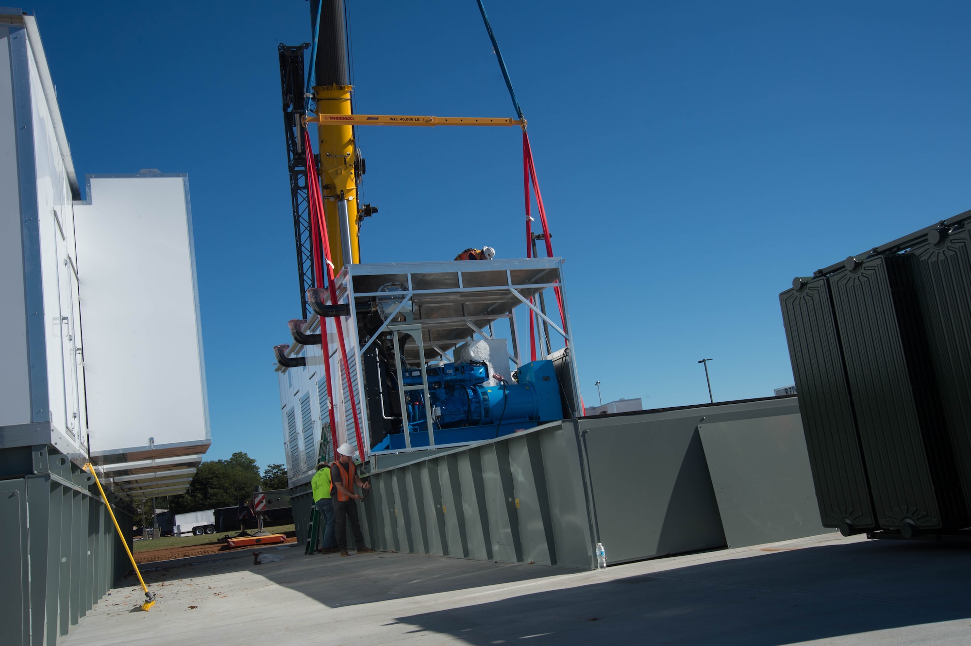 Contractors assemble a microgrid at a construction site.