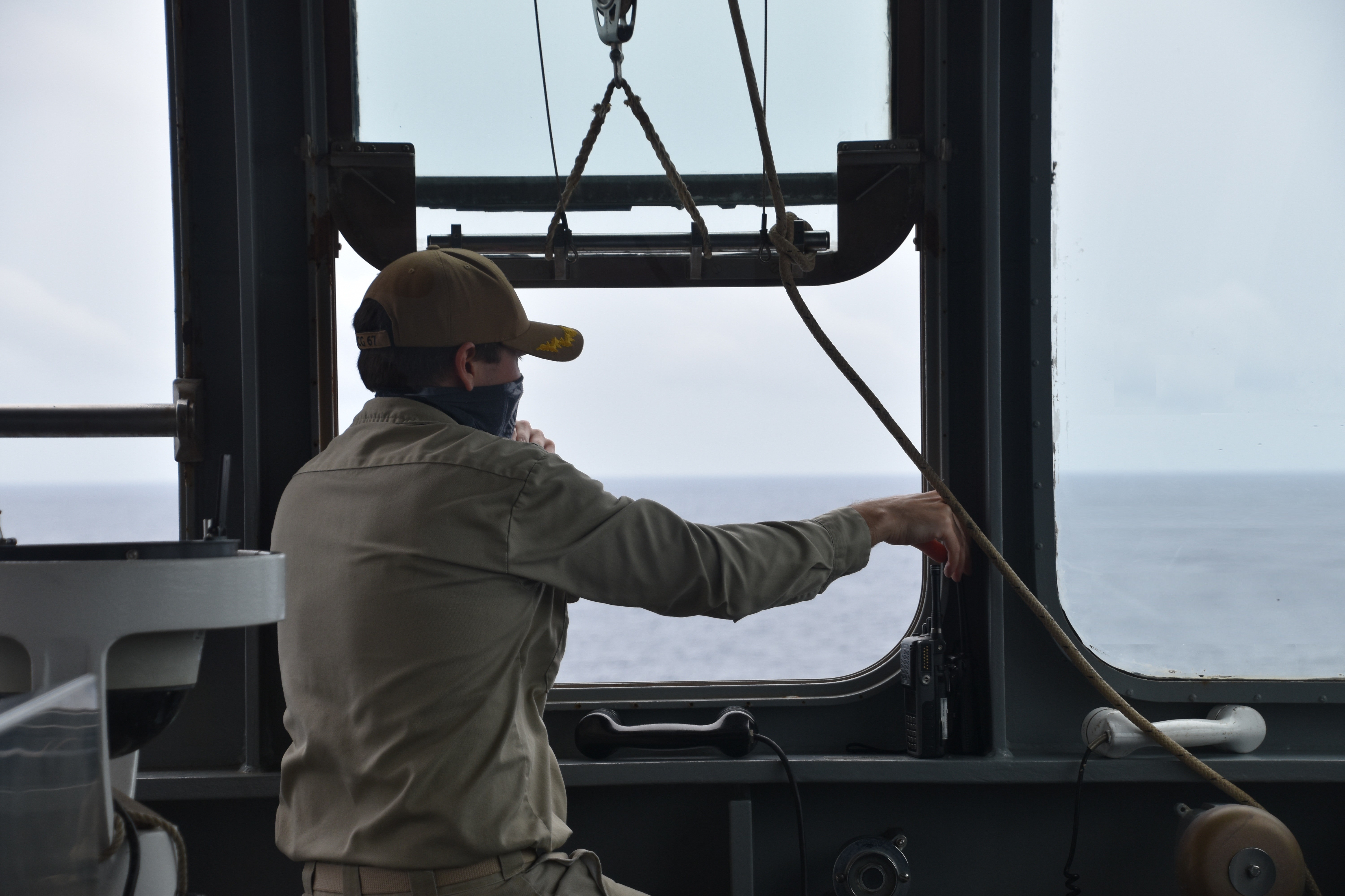 Capt. Daniel Wiseman, master of USNS Amelia Earhart (T-AKE 6), watches as his dry cargo/ammunition ship conducts a replenishment at sea with HMAS Ballarat (FFH 155), an Anzac-class frigate in the Royal Australian Navy.