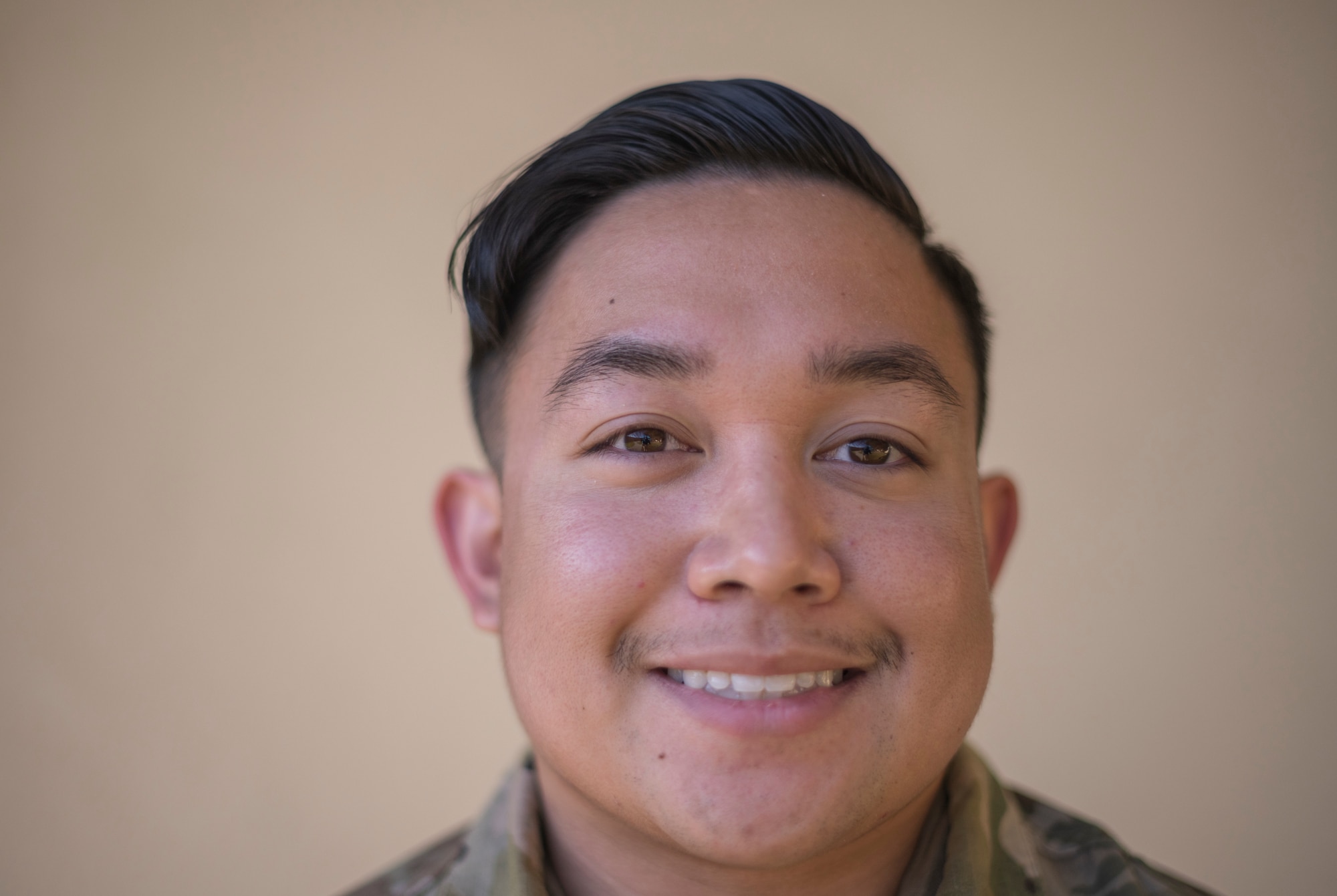 A tight frame of an airman's face photographed for a portrait.