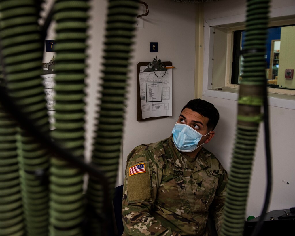 Spc. Santiago Perez, 204th Military Intelligence Battalion a cryptologic linguist, gazes around the chamber examining all the small details before a test on Nov. 23, 2020, Laughlin Air Force Base, Texas. During the chamber test, one must identify your hypoxia symptoms and perform various tasks. (U.S. Air Force photo by Airman 1st Class David Phaff)