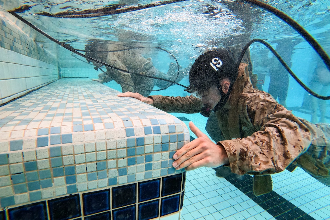 Marines use a device to breath underwater.