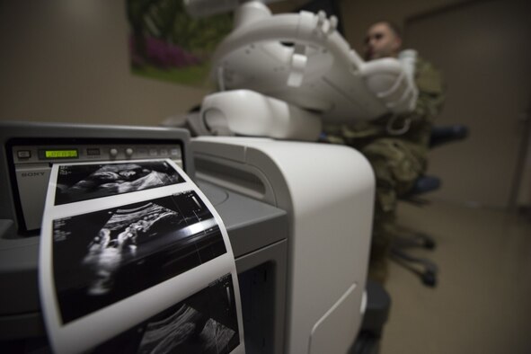 A digital graphic printer displays ultrasound photos while Staff Sgt. Nance Pea, 35th Surgical Operations Squadron ultrasound noncommissioned officer in charge, conducts an ultrasound April 10, 2019, at Misawa Air Base, Japan. The 21st Medical Group Family Advocacy Program offers assistance to expecting and new parents through their New Parent Support Program. The program is designed to provide education, support and resources for expectant parents or parents who have a child under the age of three. The parents can be adoptive, foster or biological. (U.S. Air Force photo by Senior Airman Collette Brooks)