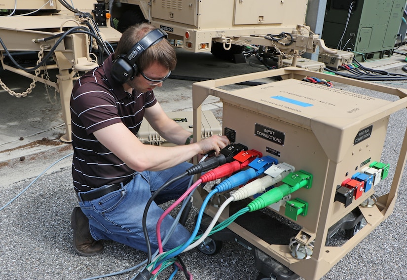 An engineer works on a machine.