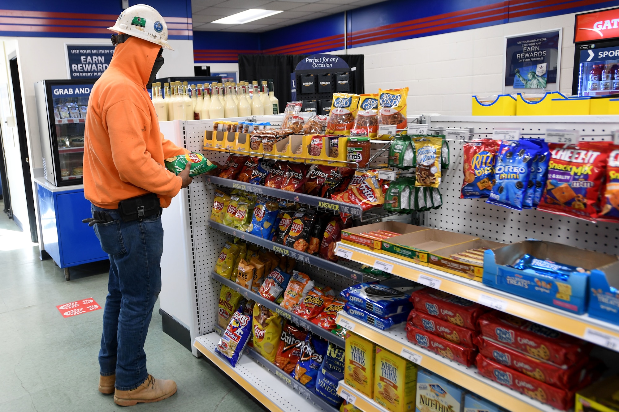 A government contractor takes a break from construction to purchase chips at the Shoppette before heading back to work at the North Carolina Air National Guard Base, Charlotte Douglas International Airport, Dec. 3, 2020. After 14 years of serving Airmen, the Base Shoppette is set to close on December 11, 2020 with plans to possibly re-open after the COVID-19 pandemic subsides.