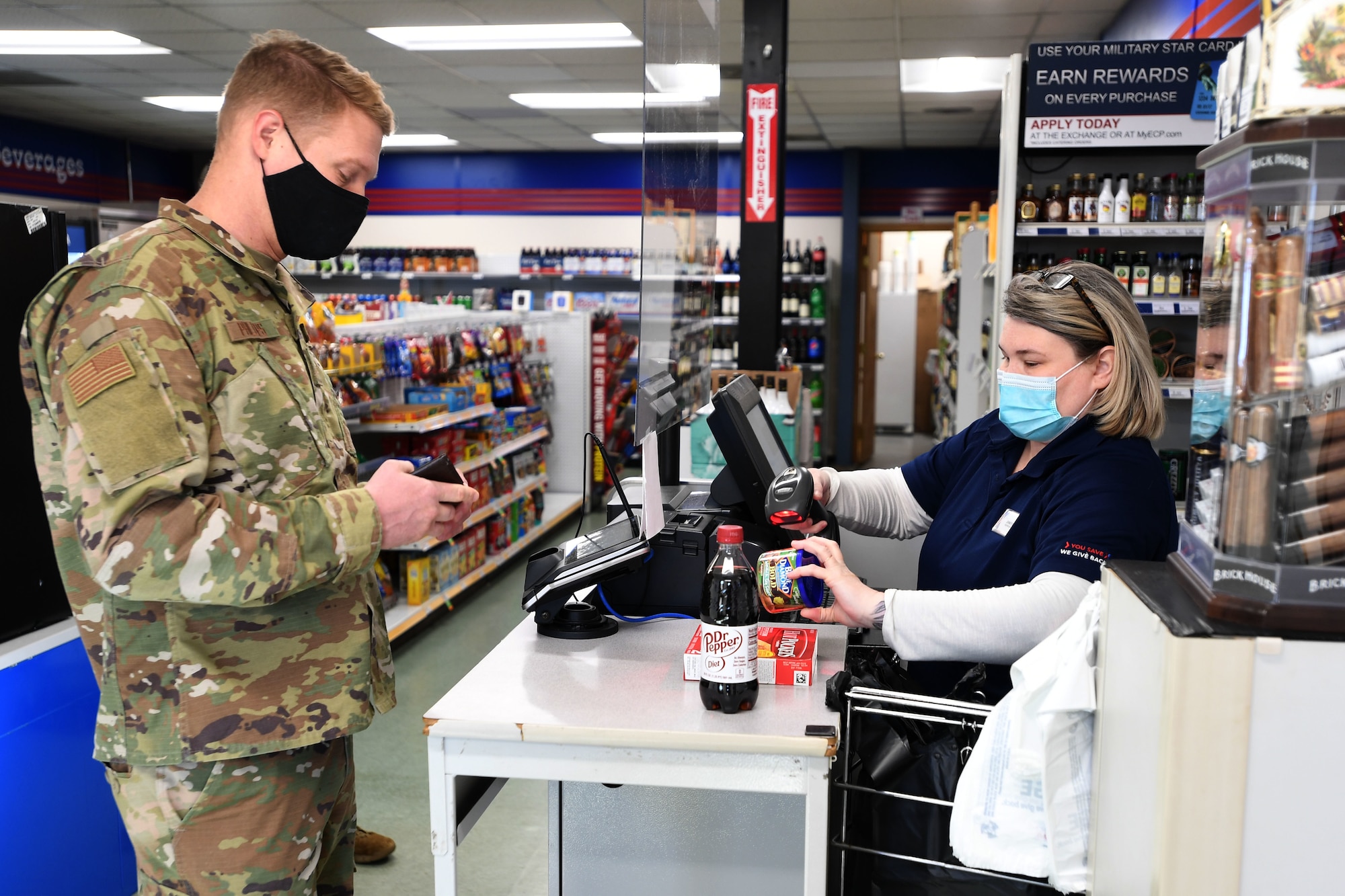 Jennifer Britton, Shoppette Store Manager, assists North Carolina Air National Guardsmen (NCANG) at the Shoppette cash register while they take a break from work to buy snacks and drinks at the NCANG Base, Charlotte Douglas International Airport, Dec. 3, 2020. After 14 years of serving Airmen, the Base Shoppette is set to close on December 11, 2020 with plans to possibly re-open after the COVID-19 pandemic subsides.
