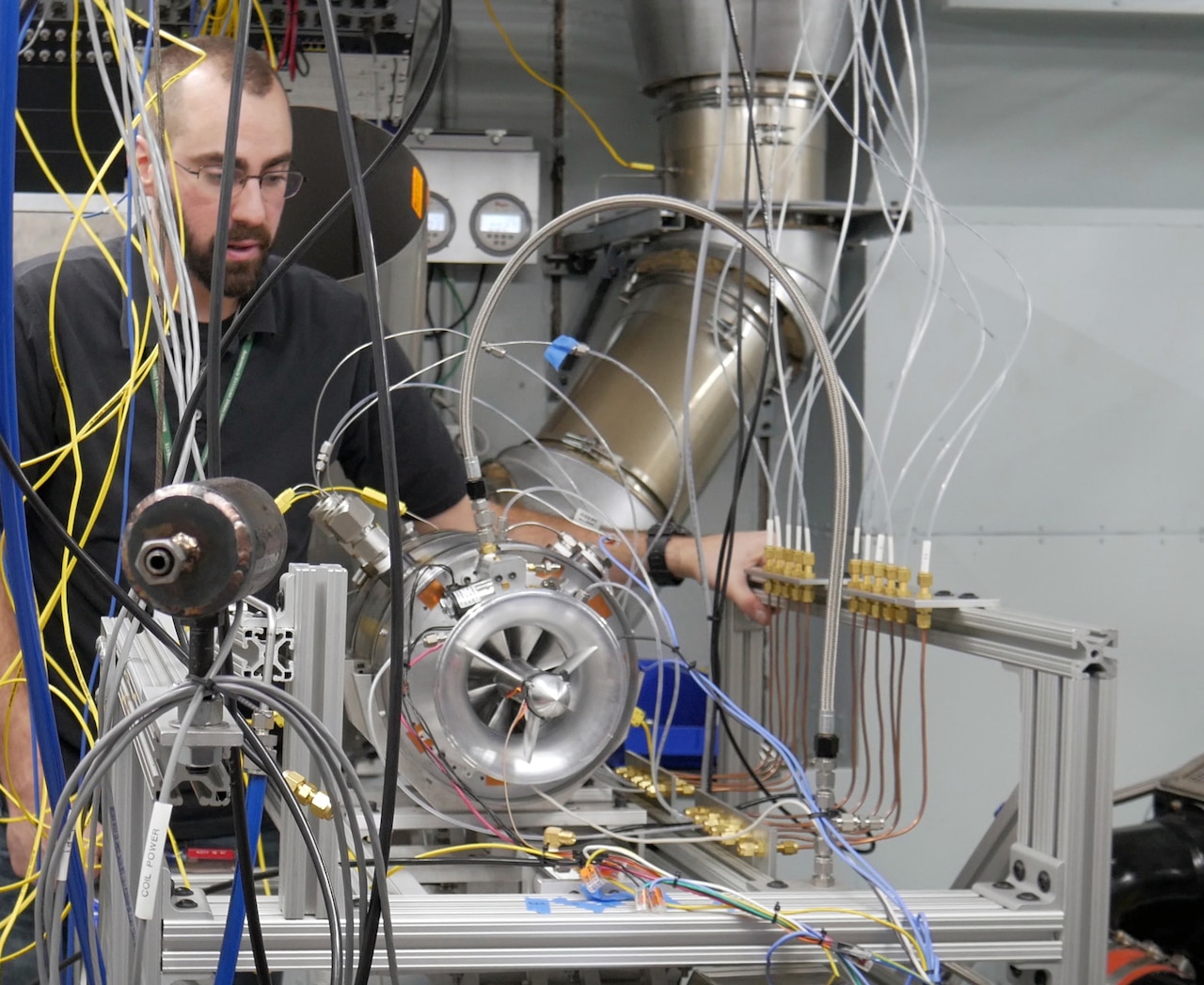 A man works on electronic gear.