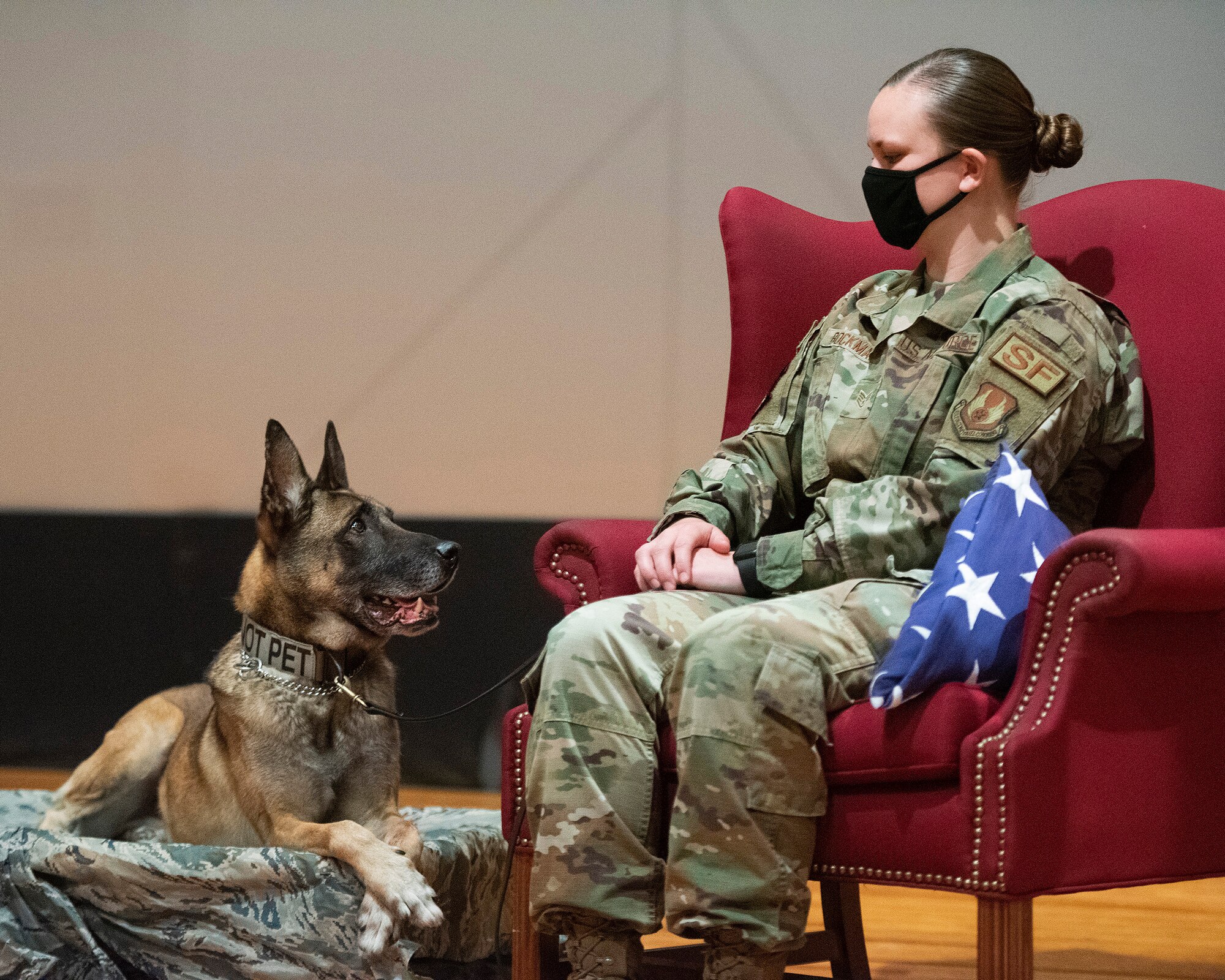 Military Working Dog Rudo and his handler, Staff Sgt. Lacey Bockman, 88th Security Forces Squadron, at his retirement ceremony in the Wright-Patterson Air Force Base, Ohio, theater Nov. 16, 2020. Rudo’s retirement plans are to move in with Bockman and her two other dogs. (U.S. Air Force photo by R.J. Oriez)
