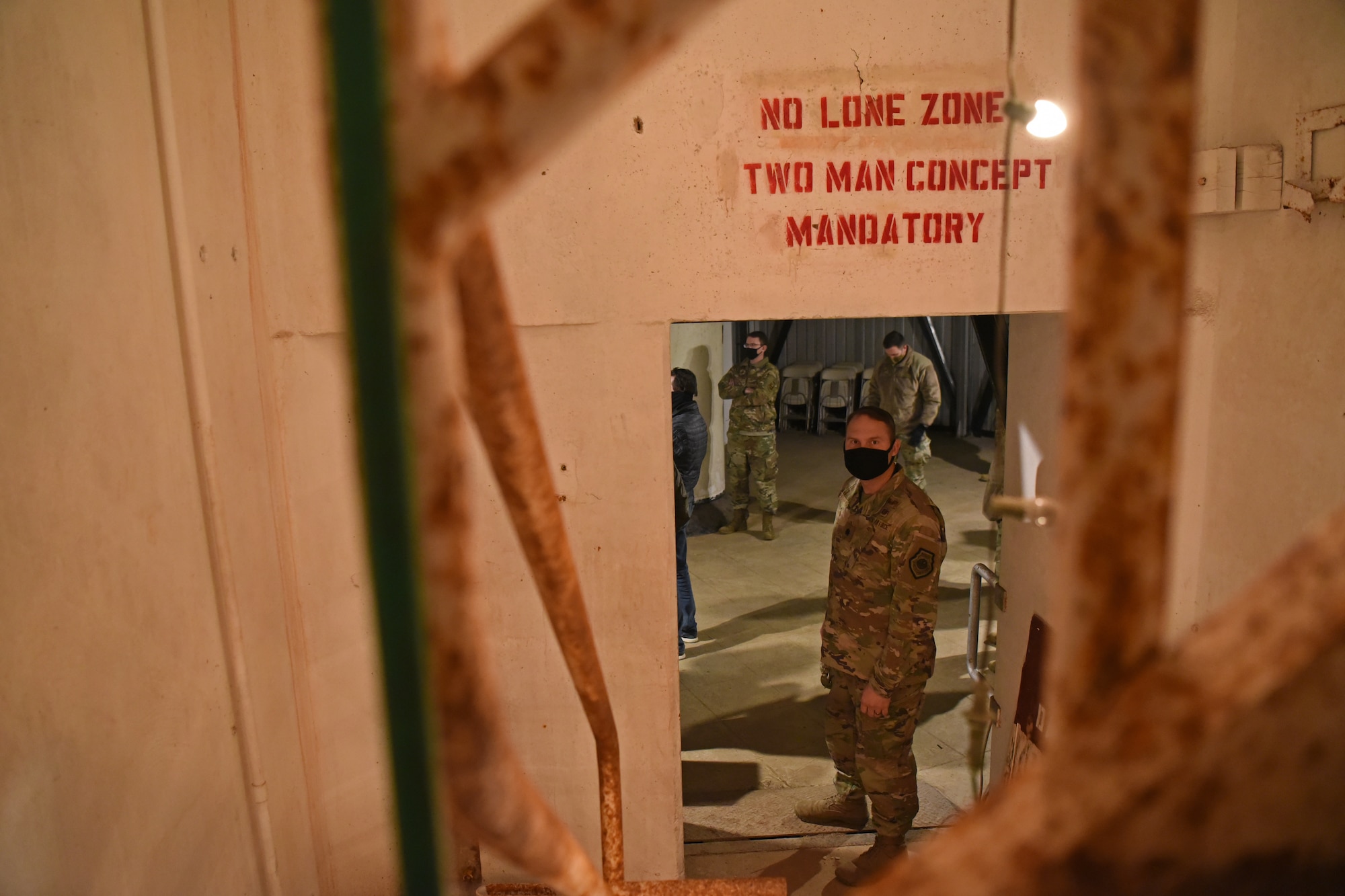 U.S. Air Force Lt Col. John Bergmans, 315th Training Squadron commander, enters the Lawn Atlas Missile Base’s missile silo while exploring the narratives of actual personnel deployed to the site during the Cuban Missile Crisis in Lawn, Texas, Dec. 3, 2020. Bergmans attended the Staff Ride to LAMB in support of the 17th Training Wing Heritage Campaign Plan that was founded on Air Force heritage and the Airmen Warrior Ethos among attending personnel.. (U.S. Air Force photo by Senior Airman Abbey Rieves)
