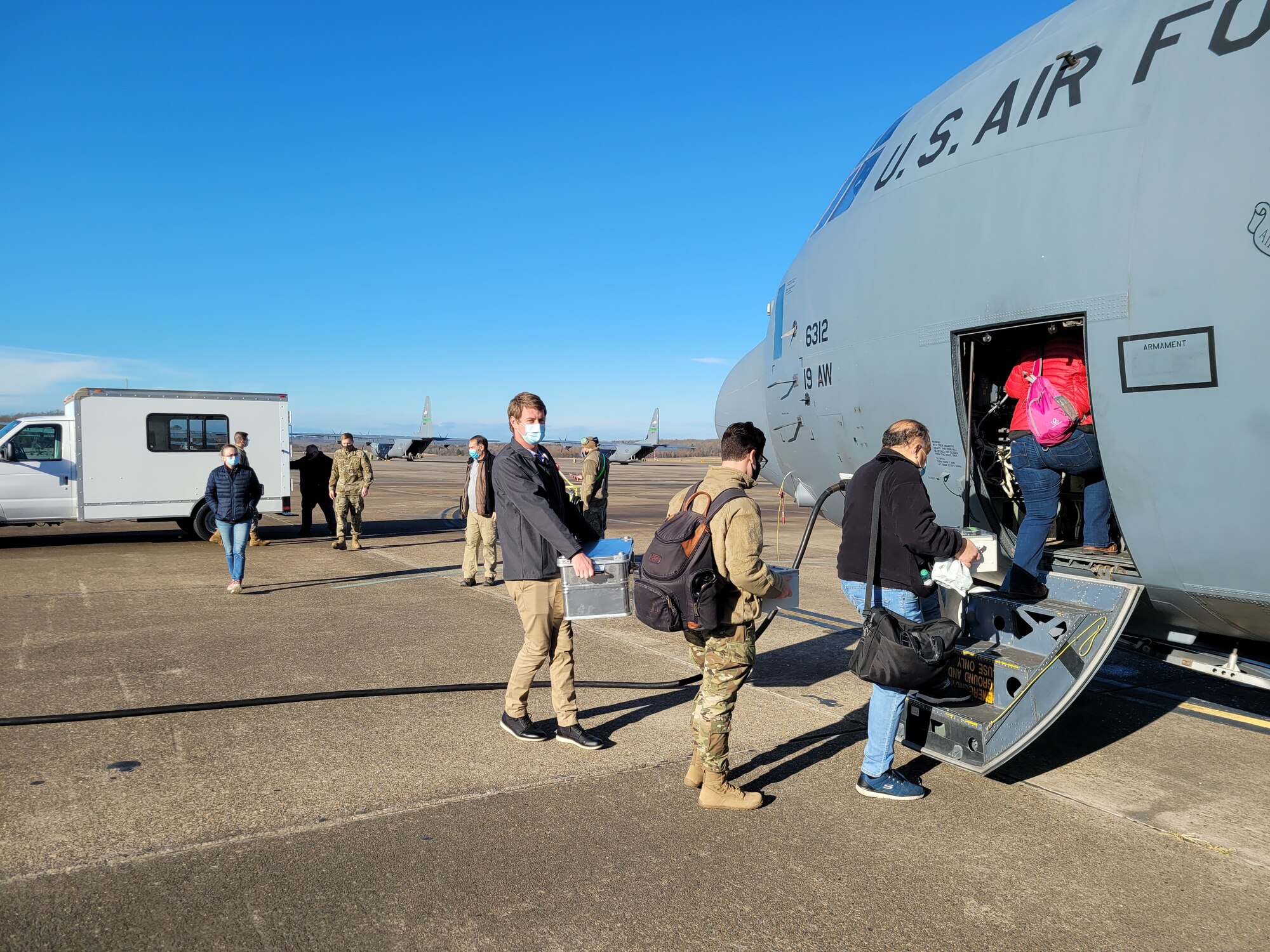 People boarding C-130