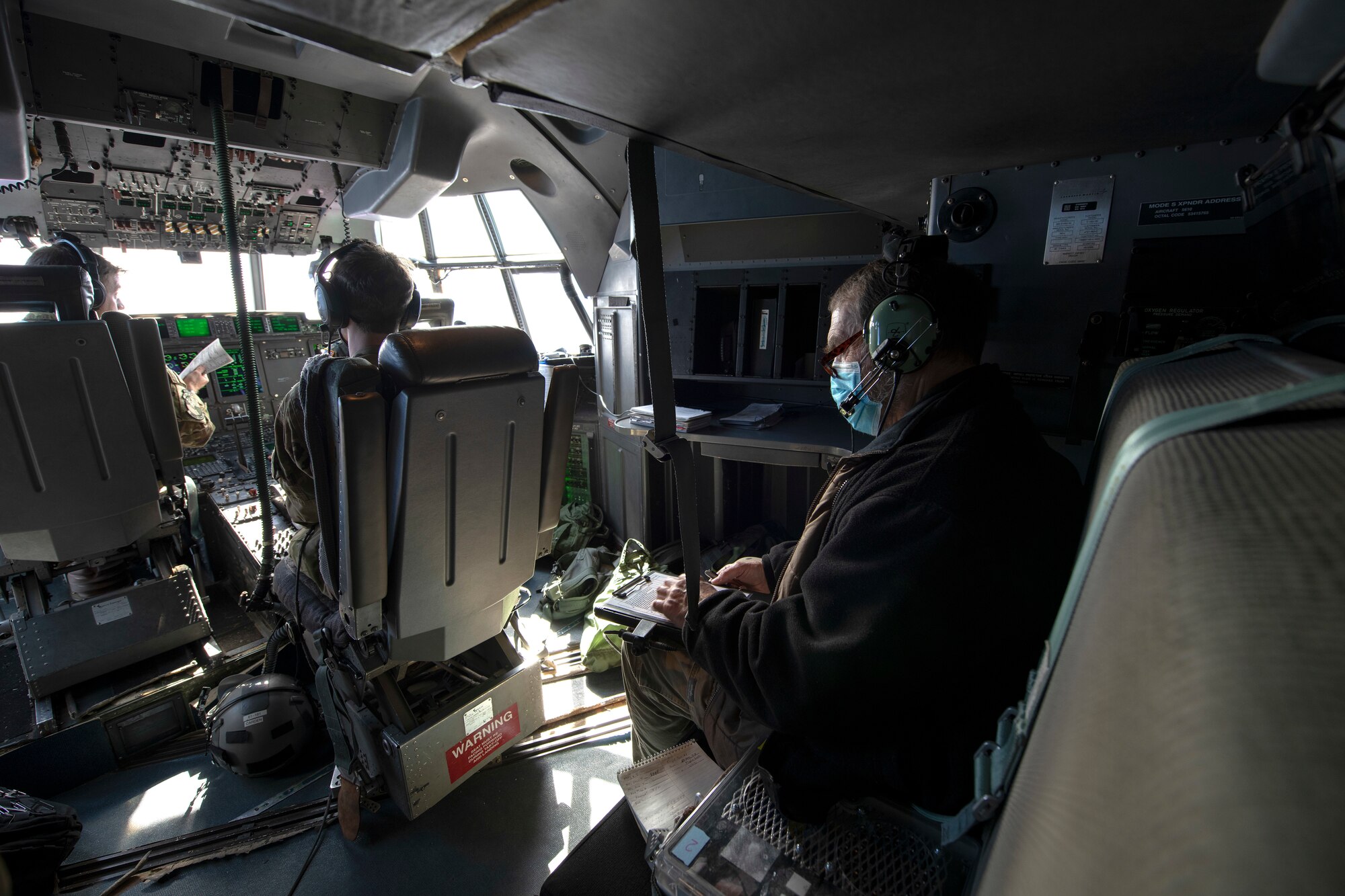 Three people sitting in airplane cockpit
