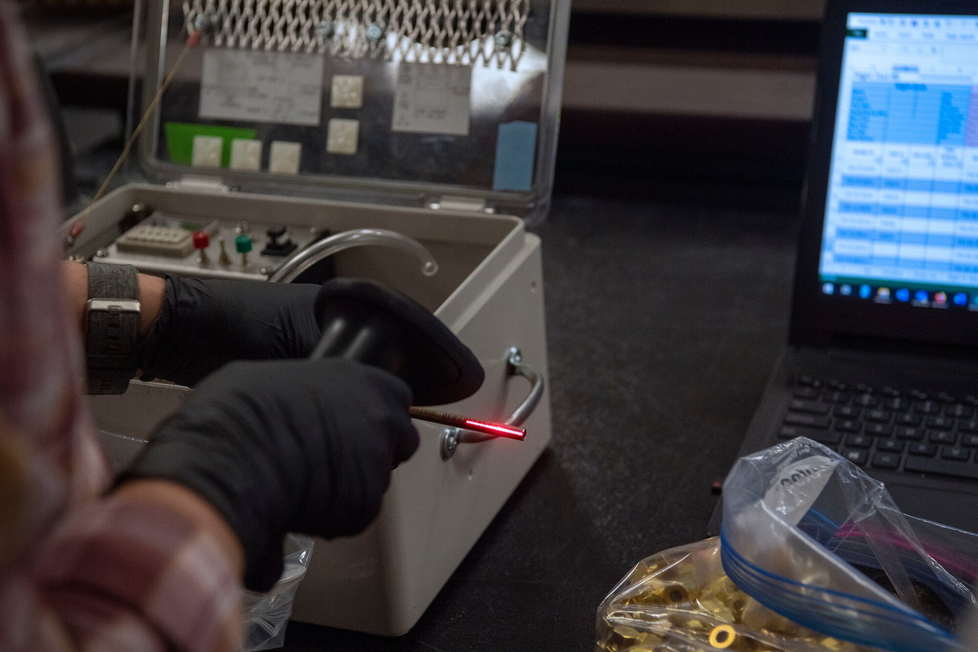 hands wearing gloves with vapor tube