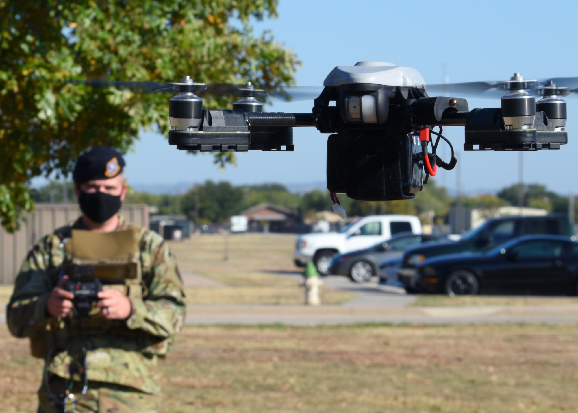 U.S. Air Force Tech. Sgt. Kyle McNeill, 17th Security Forces Squadron bravo flight chief and certified drone operator, creates a line of vision for the drone that he is operating outside of the 17th SFS headquarters, on Goodfellow Air Force Base, Texas, Nov. 5, 2020. The 17th SFS plans to expand its training to utilize the drone as a quick reaction tool in unpredictable situations. (U.S. Air Force photo by Airman 1st Class Ethan Sherwood)