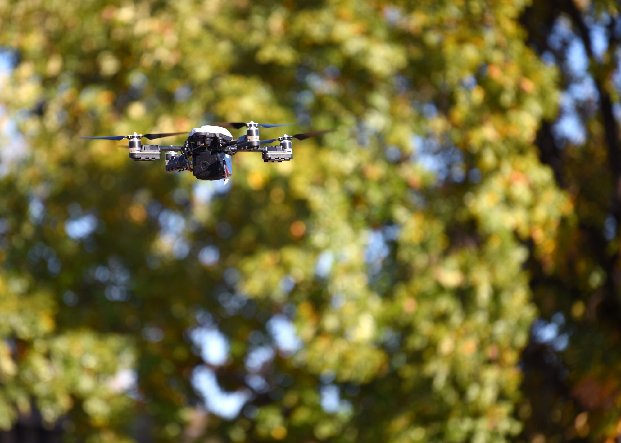 A Small Unmanned Aircraft System, commonly known as a drone, from the U.S. Air Force 17th Security Forces Squadron whips through the air outside of the 17th SFS headquarters, on Goodfellow Air Force Base, Texas, Nov. 5, 2020.  The installation drones held integrated technologies and a high capacity camera, thermal detection and other customizable capabilities, which will be utilized as a force multiplier at different squadrons throughout the base. (U.S. Air Force photo by Airman 1st Class Ethan Sherwood)