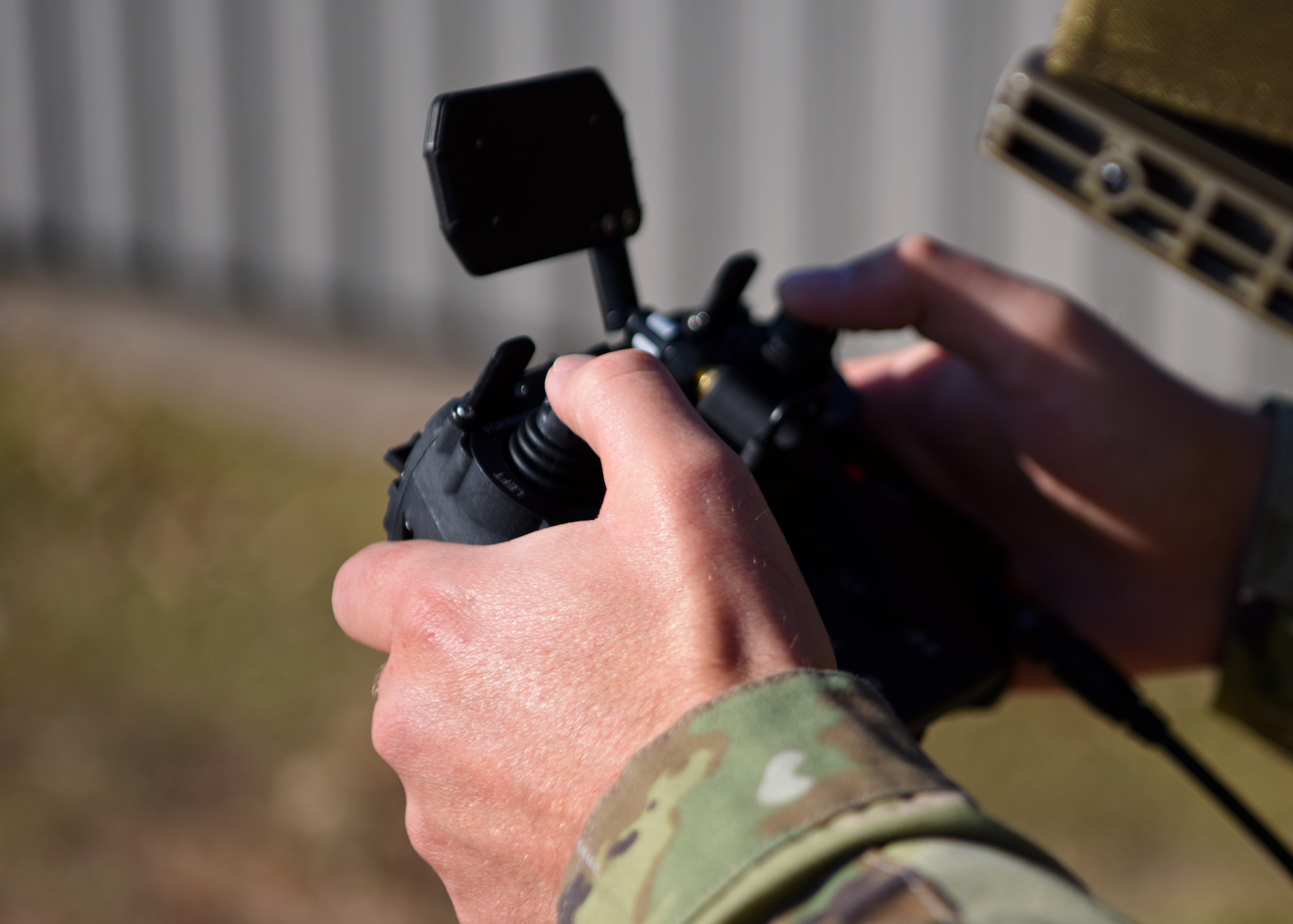 U.S. Air Force Tech. Sgt. Kyle McNeill, 17th Security Forces Squadron bravo flight chief and certified drone operator, maneuvers a drone controller to achieve an optimal vantage point for the drone’s camera outside of the 17th SFS headquarters, on Goodfellow Air Force Base, Texas, Nov. 5, 2020.  The drone added extra security and offered more advanced, deterrent capabilities around the installation, all from a single controller. (U.S. Air Force photo by Airman 1st Class Ethan Sherwood)